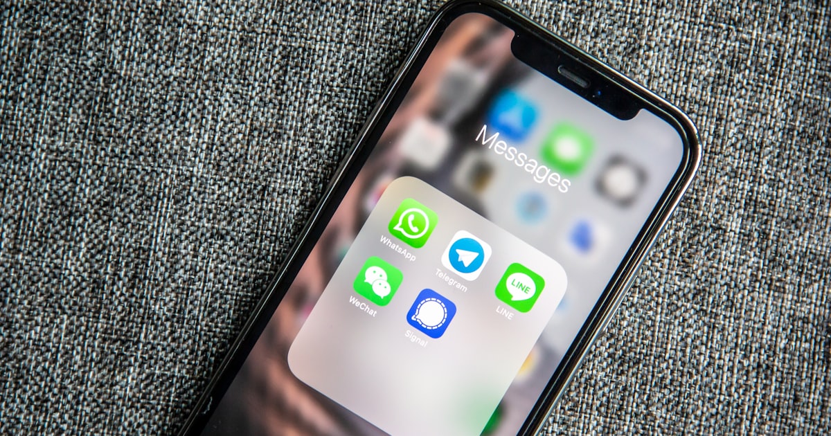 Écran de smartphone dans la pénombre, illustration d'un appel entrant affichant un numéro bancaire usurpé